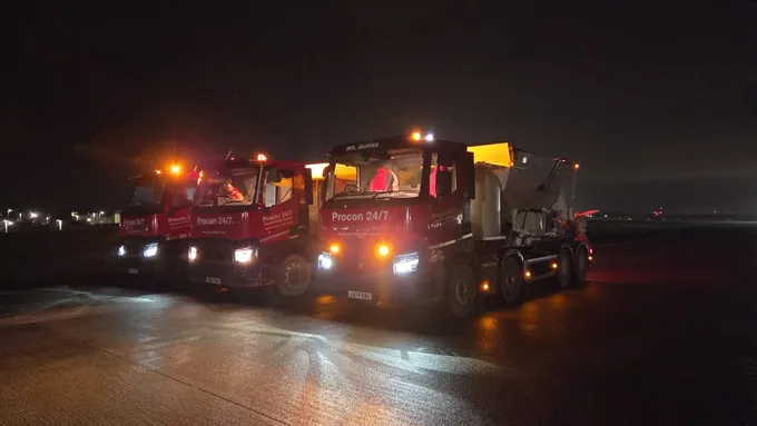 Three Procon 24/7 volumetric mixers on an airfield at night