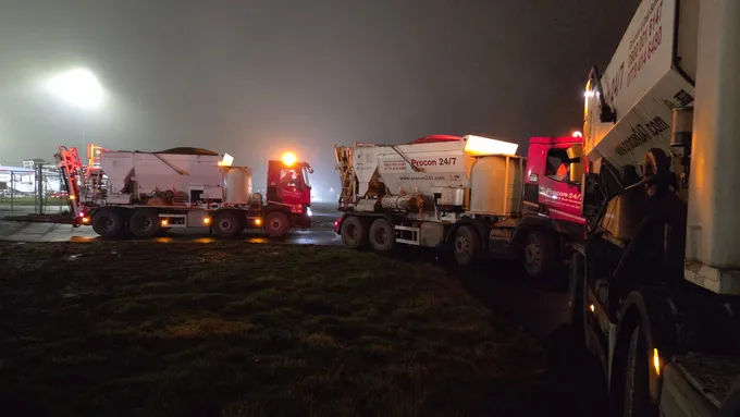 Procon mixers queuing through an airport security check at night