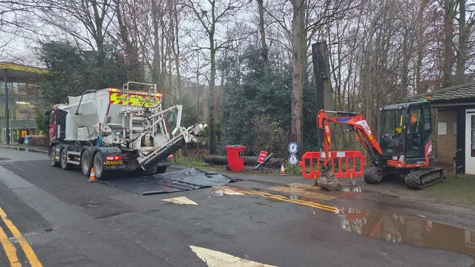 Procon volumetric mixer pouring concrete from the back chute on a roadside job