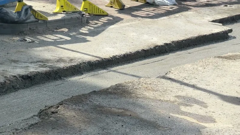 Filled and levelled foamed concrete trench reinstatement flush with the carriageway surface